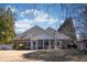 Expansive backyard featuring a red brick house with a screened-in porch and mature trees at 520 Camp Perrin Rd, Lawrenceville, GA 30043