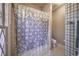 Quaint bathroom featuring tile floors, a shower, and a patterned shower curtain at 520 Camp Perrin Rd, Lawrenceville, GA 30043