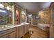 Bathroom featuring a double vanity, decorative wallpaper, and soaking tub at 520 Camp Perrin Rd, Lawrenceville, GA 30043