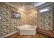 Bathroom featuring a corner soaking tub and floral wallpaper at 520 Camp Perrin Rd, Lawrenceville, GA 30043