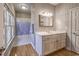 Cozy bathroom featuring a vanity, mirror, and tub shower at 520 Camp Perrin Rd, Lawrenceville, GA 30043