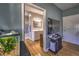 Bathroom with a sink, white cabinets and a walk-in shower, with hardwood floors in adjacent room at 520 Camp Perrin Rd, Lawrenceville, GA 30043