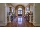 An entryway with a chandelier, hardwood floors, and classic architectural details at 520 Camp Perrin Rd, Lawrenceville, GA 30043