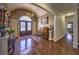 Grand foyer with hardwood floors, piano, chandelier, and decorative columns at 520 Camp Perrin Rd, Lawrenceville, GA 30043