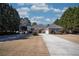 Traditional brick home with mature trees and a long driveway leading to the residence at 520 Camp Perrin Rd, Lawrenceville, GA 30043