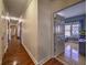 Hallway with hardwood floors leading to an open room with natural light at 520 Camp Perrin Rd, Lawrenceville, GA 30043