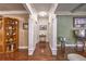 Hallway with hardwood floors and decorative columns leads to other rooms in the home at 520 Camp Perrin Rd, Lawrenceville, GA 30043