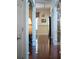 Bright hallway with polished hardwood floors and decorative columns, creating a sense of openness at 520 Camp Perrin Rd, Lawrenceville, GA 30043