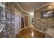 Hallway with hardwood floors, floral wallpaper, closet, and access to the bathroom at 520 Camp Perrin Rd, Lawrenceville, GA 30043