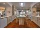 Traditional kitchen with a central island, hardwood floors and light wood cabinets at 520 Camp Perrin Rd, Lawrenceville, GA 30043