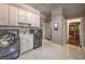 Bright laundry room featuring modern appliances and ample cabinet space at 520 Camp Perrin Rd, Lawrenceville, GA 30043