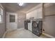 Laundry room with washer, dryer and storage cabinets at 520 Camp Perrin Rd, Lawrenceville, GA 30043