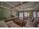 Inviting living room features hardwood floors, coffered ceiling, fireplace, and sliding doors to outdoor space at 520 Camp Perrin Rd, Lawrenceville, GA 30043