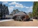 Home shows a glimpse of a metal carport, lush greenery, and a well-manicured lawn at 520 Camp Perrin Rd, Lawrenceville, GA 30043