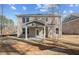 Brick home's backyard featuring a covered patio with a ceiling fan at 249 Chiswick Loop, Stockbridge, GA 30281