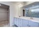Contemporary bathroom with double vanity, modern lighting, and a large framed mirror at 249 Chiswick Loop, Stockbridge, GA 30281