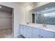 Modern bathroom featuring double sink vanity, walk-in closet, and tiled shower at 249 Chiswick Loop, Stockbridge, GA 30281