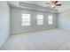 Large bedroom with trey ceiling and abundant natural light from three large windows at 249 Chiswick Loop, Stockbridge, GA 30281