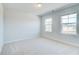 Bright bedroom with two windows and neutral-colored walls at 249 Chiswick Loop, Stockbridge, GA 30281