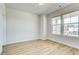Bright bedroom with two windows, light wood floors and fresh white walls at 249 Chiswick Loop, Stockbridge, GA 30281