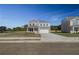 New two-story home with a two-car garage, porch and gray brickwork at 249 Chiswick Loop, Stockbridge, GA 30281