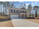 Charming two-story brick home with a well-manicured lawn and attached two-car garage at 249 Chiswick Loop, Stockbridge, GA 30281