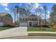 Charming two-story brick home with a well-manicured lawn and attached two-car garage at 249 Chiswick Loop, Stockbridge, GA 30281