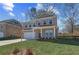 Charming two-story brick home with a well-manicured lawn and attached two-car garage at 249 Chiswick Loop, Stockbridge, GA 30281