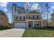 Charming two-story brick home with a manicured lawn and covered front porch at 249 Chiswick Loop, Stockbridge, GA 30281