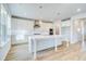 Bright kitchen with white cabinetry, stainless steel appliances, and a spacious center island at 249 Chiswick Loop, Stockbridge, GA 30281