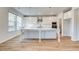 Bright, white kitchen featuring an island, stainless steel appliances, and stylish pendant lighting at 249 Chiswick Loop, Stockbridge, GA 30281