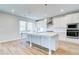 Bright, white kitchen featuring an island, stainless steel appliances, and stylish pendant lighting at 249 Chiswick Loop, Stockbridge, GA 30281