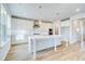 Bright, white kitchen featuring an island, stainless steel appliances, and stylish pendant lighting at 249 Chiswick Loop, Stockbridge, GA 30281