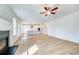 Open-concept living room and kitchen with white cabinets and stainless steel appliances at 249 Chiswick Loop, Stockbridge, GA 30281