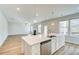 Open-concept living space with a fireplace, hardwood floors, and plenty of natural light at 249 Chiswick Loop, Stockbridge, GA 30281