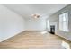 Bright, open living room featuring a fireplace and light hardwood floors at 249 Chiswick Loop, Stockbridge, GA 30281
