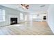 Spacious living room with a fireplace and access to the kitchen and backyard at 249 Chiswick Loop, Stockbridge, GA 30281