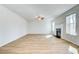 Inviting living room features wood-look floors, a cozy fireplace, and lots of natural light at 249 Chiswick Loop, Stockbridge, GA 30281