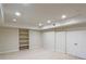 Finished basement features recessed lighting, built-in shelving, and a double door closet for storage at 3348 Terrace Hedge Pl, Dacula, GA 30019