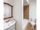 Bathroom with a decorative mirror, modern vanity, and a tiled shower-tub combination at 3348 Terrace Hedge Pl, Dacula, GA 30019