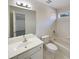 Bright bathroom featuring a vanity sink, toilet, and a shower-tub combination at 3348 Terrace Hedge Pl, Dacula, GA 30019