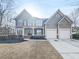 Two-story home with a manicured lawn, a two-car garage, and a covered porch at 3348 Terrace Hedge Pl, Dacula, GA 30019