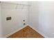 A dedicated laundry area featuring tile floors, laundry hookups, and wire shelving for storage at 3348 Terrace Hedge Pl, Dacula, GA 30019