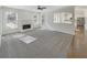 Bright living room featuring a fireplace, ceiling fan, and large windows providing ample natural light at 3348 Terrace Hedge Pl, Dacula, GA 30019