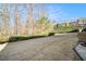 A view of the expansive backyard including trees, bushes, and grass at 5751 Evadale Trace, Mableton, GA 30126