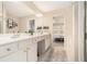 Bathroom featuring double sinks with white cabinets and an adjacent door to bedroom at 5751 Evadale Trace, Mableton, GA 30126