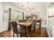 Elegant dining room features hardwood floors, modern lighting, and sliding door access to the outdoors at 5751 Evadale Trace, Mableton, GA 30126