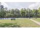 Well-maintained tennis courts with benches and ample space, set against a backdrop of mature trees at 5751 Evadale Trce # 4, Mableton, GA 30126