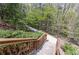 An inviting community walking path descends a staircase, surrounded by lush greenery at 5751 Evadale Trace, Mableton, GA 30126