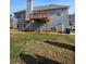 Back exterior of home showcasing grey siding and elevated deck at 7603 Autumn Breeze, Douglasville, GA 30134